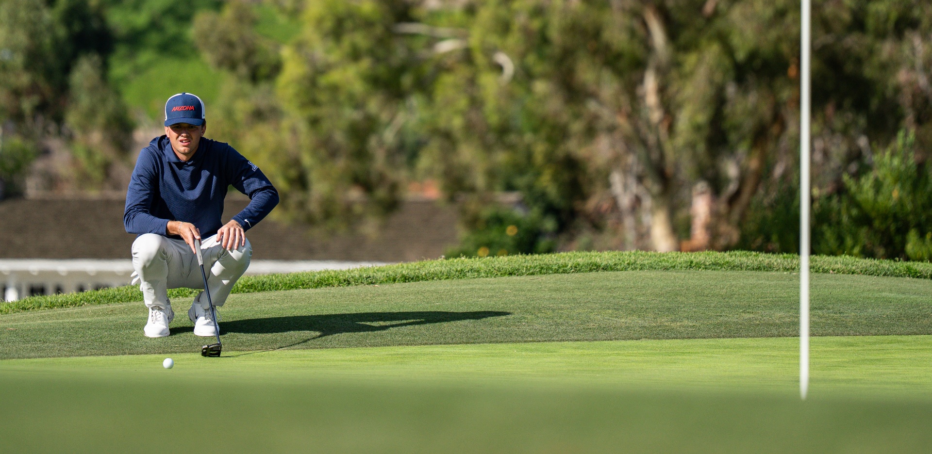 Connor Hamm lining up a putt